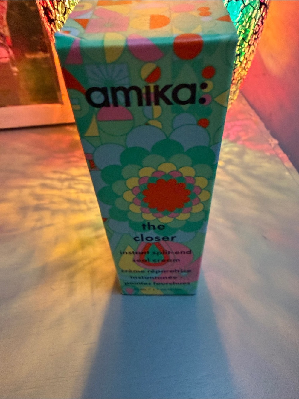 amika colorful patterned serum box with green and teal accents